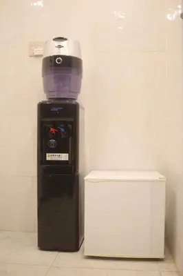 a food processor sitting next to a white refrigerator at MIYAVI hotel in Tokyo