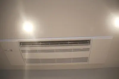 a air conditioner in a room with two lights at MIYAVI hotel in Tokyo