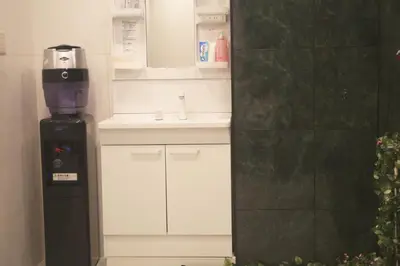 a kitchen with a coffee maker on top of a refrigerator at MIYAVI hotel in Tokyo