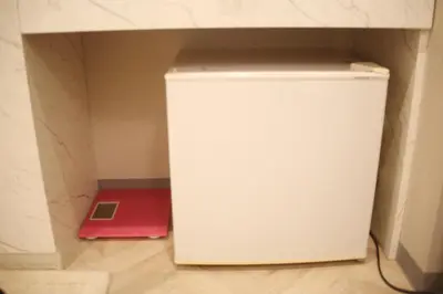 a white refrigerator in a room with a red box at MIYAVI hotel in Tokyo