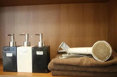 a bathroom with two bottles of soap and a racket at MIYAVI hotel in Tokyo