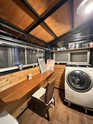 a laundry room with a washing machine and a chair at \u5317\u5343\u4f4f\u306e\u4e00\u8ed2\u5bb6\u4ea4\u901a\u306e\u5229\u4fbf\u6027k1 in Tokyo