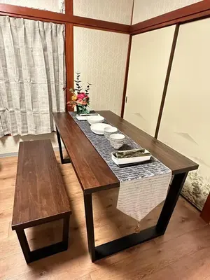 a wooden table with bowls and plates on it at \u5317\u5343\u4f4f\u306e\u4e00\u8ed2\u5bb6\u4ea4\u901a\u306e\u5229\u4fbf\u6027k1 in Tokyo