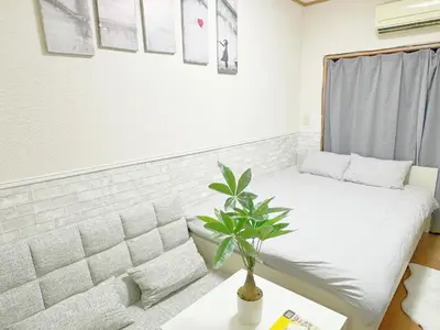 a room with a bed and a plant in it at \u6c60\u888b\u96fb\u8eca2\u5206\u6700\u59274\u4eba 302 in Tokyo