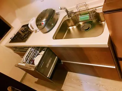 a kitchen with a sink and a stove at \u4e09\u30ce\u8f2a201 in Tokyo