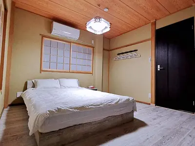 a bedroom with a large bed and a window at \u4e09\u30ce\u8f2a201 in Tokyo