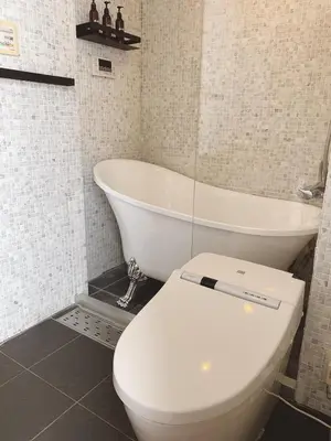 a bathroom with a toilet and a bath tub at EstLargo Meguro in Tokyo