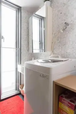 a white bathroom with a sink and a mirror at EstLargo Meguro in Tokyo