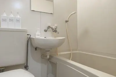 a white bathroom with a sink and a bath tub at \u30e1\u30be\u30f3\u30c9\u30df\u30ca101\u53f7\u5ba4 in Tokyo