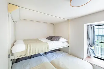 two beds in a small room with a window at \u30e1\u30be\u30f3\u30c9\u30df\u30ca101\u53f7\u5ba4 in Tokyo