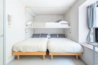 two beds in a room with white walls at \u30e1\u30be\u30f3\u30c9\u30df\u30ca101\u53f7\u5ba4 in Tokyo