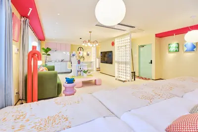 a bedroom with two beds and a living room at \u5bc5\u30db\u30c6\u30eb \u5fa1\u5f92\u753a TORA HOTEL Okachimachi in Tokyo