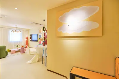 a living room with a picture of a cloud on the wall at \u5bc5\u30db\u30c6\u30eb \u5fa1\u5f92\u753a TORA HOTEL Okachimachi in Tokyo