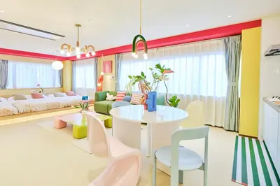 a living room with a white table and chairs at \u5bc5\u30db\u30c6\u30eb \u5fa1\u5f92\u753a TORA HOTEL Okachimachi in Tokyo