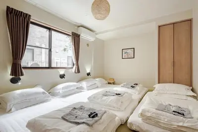 a room with four beds in it with a window at Tokoryokan - Takasago - Vacation STAY 58684v in Tokyo