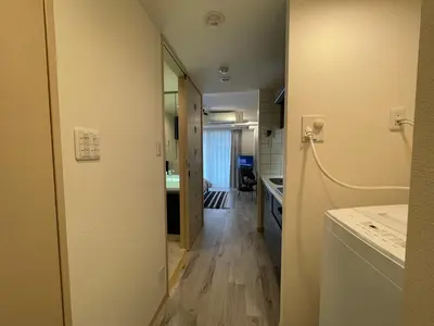 a hallway leading to a kitchen and a bathroom at Dash Living Ryogoku in Tokyo