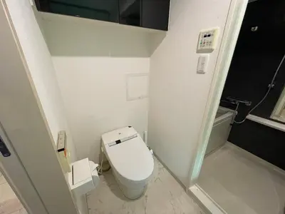 a small bathroom with a toilet and a sink at Dash Living Ryogoku in Tokyo