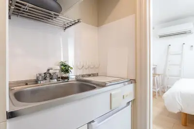 a kitchen with a sink and a bed in a room at \u30e1\u30be\u30f3\u30c9\u30df\u30ca102\u53f7\u5ba4 in Tokyo