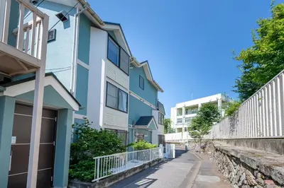 a row of apartment buildings on a street at \u30e1\u30be\u30f3\u30c9\u30df\u30ca103\u53f7\u5ba4 in Tokyo