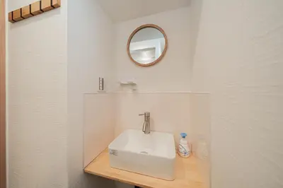 a bathroom with a white sink and a mirror at Tokyo Ichiban Kabukicho in Tokyo