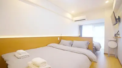a bedroom with two beds with towels on them at Tokyo Ichiban Kabukicho in Tokyo