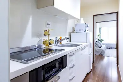 a white kitchen with a sink and a refrigerator at NishiShinjuku5chome sta 5 mins walk Max 5 people in Tokyo
