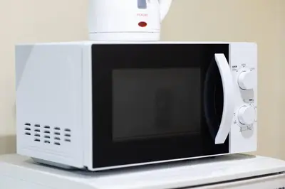 a white microwave oven with a controller on top of it at NishiShinjuku5chome sta 5 mins walk Max 5 people in Tokyo