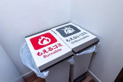 a pile of boxes sitting on top of a trash can at NishiShinjuku5chome sta 5 mins walk Max 5 people in Tokyo