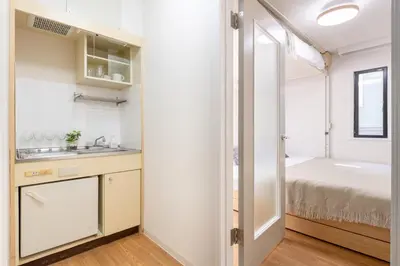 a small bathroom with a sink and a bed at \u30e1\u30be\u30f3\u30c9\u30df\u30ca201\u53f7\u5ba4 in Tokyo