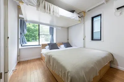 a bedroom with a large bed and a window at \u30e1\u30be\u30f3\u30c9\u30df\u30ca201\u53f7\u5ba4 in Tokyo