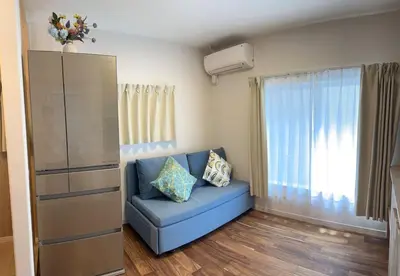 a living room with a blue couch and a window at Mizuken Home Three bedrooms For Family Team in Tokyo