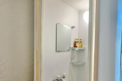a bathroom with a shower and a mirror at Mizuken Home Three bedrooms For Family Team in Tokyo