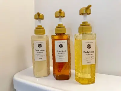 three bottles of different colored liquids sitting on a shelf at Mizuken Home Three bedrooms For Family Team in Tokyo