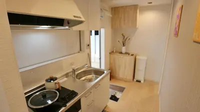 a small kitchen with a sink and a stove at Mizuken Home Three bedrooms For Family Team in Tokyo