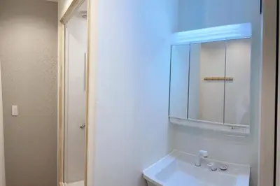 a white bathroom with a sink and a mirror at Mizuken Home Three bedrooms For Family Team in Tokyo
