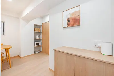 a kitchen with a counter and a table in a room at ZAITO TOKYO RYOGOKU Hotel in Tokyo