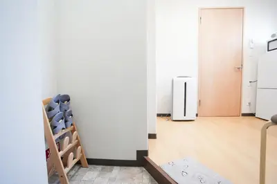 a room with a white wall and a refrigerator at Asakusa 5 Chome One Bedroom KazeNoItsu 201 in Tokyo