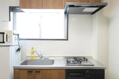 a kitchen with a sink and a microwave at Asakusa 5 Chome One Bedroom KazeNoItsu 201 in Tokyo