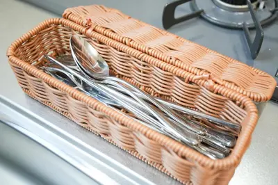 a wicker basket with spoons and forks on a counter at Asakusa 5 Chome One Bedroom KazeNoItsu 201 in Tokyo