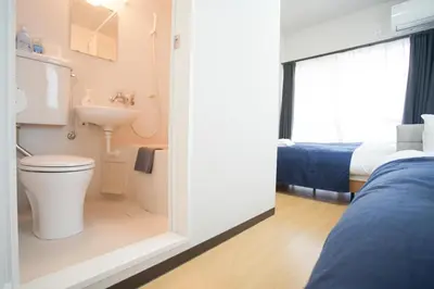 a bathroom with a toilet and a sink and a bed at Asakusa 5 Chome One Bedroom KazeNoItsu 201 in Tokyo