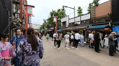 a crowd of people walking down a busy city street at Asakusa 5 Chome One Bedroom KazeNoItsu 401 in Tokyo
