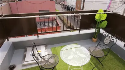 an overhead view of a balcony with a table and chairs at Asakusa 5 Chome One Bedroom KazeNoItsu 401 in Tokyo