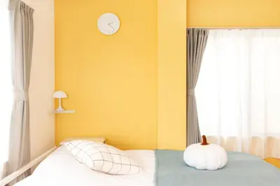 a bedroom with a bed with a clock on the wall at FIKA Shibuya Honmachi 201 in Tokyo