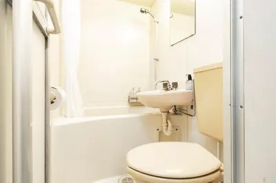 a small bathroom with a toilet and a sink at FIKA Shibuya Honmachi 201 in Tokyo