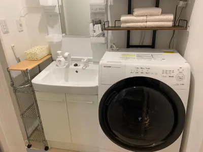 a laundry room with a washing machine and a sink at Luna House ASAKUSA TOKYO SKYTREE in Tokyo