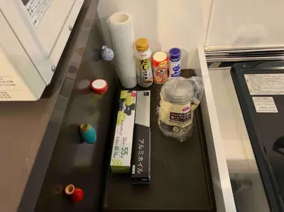 a refrigerator with food and drinks on a counter at Luna House ASAKUSA TOKYO SKYTREE in Tokyo