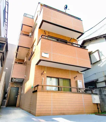 a tall brick building with a balcony at FIKA Shibuya Honmachi 202 in Tokyo