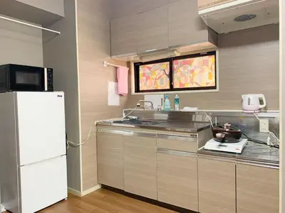 a kitchen with a sink and a refrigerator at Shinjuku Kabukicho lions mansion#Shinjuku Center#2 bed rooms#\u65b0\u5bbf\u4e2d\u5fc3\u5730\u5e26 \u6b4c\u821e\u4f0e\u753a \u8f66\u7ad9\u6b65\u884c2\u5206#2\u4e2a\u5367\u5ba4\u516c\u5bd3#Autolock#\u9ad8\u901f\u65e0\u9650\u5236\u7f51\u7edc306 in Tokyo