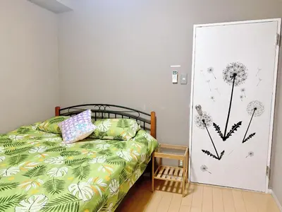 a bedroom with a bed and a door with dandelions on it at Shinjuku Kabukicho lions mansion#Shinjuku Center#2 bed rooms#\u65b0\u5bbf\u4e2d\u5fc3\u5730\u5e26 \u6b4c\u821e\u4f0e\u753a \u8f66\u7ad9\u6b65\u884c2\u5206#2\u4e2a\u5367\u5ba4\u516c\u5bd3#Autolock#\u9ad8\u901f\u65e0\u9650\u5236\u7f51\u7edc306 in Tokyo