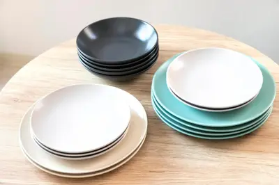 two white plates and two black bowls on a table at FIKA Shibuya Honmachi 301 in Tokyo